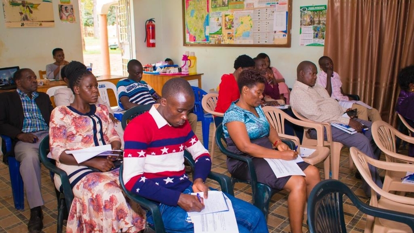 Rakai local government officials taking notes during the dialogue at Rakai municipal headquarters.